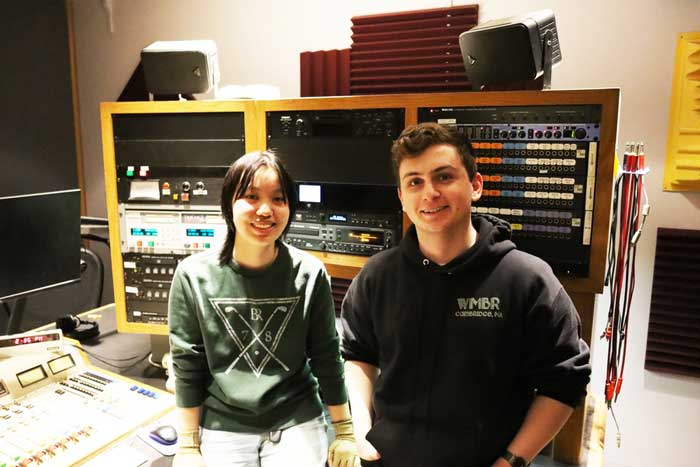 WMBR general managers Maggie Lin (left) and James Rock in the radio station with mixer and equipment in background